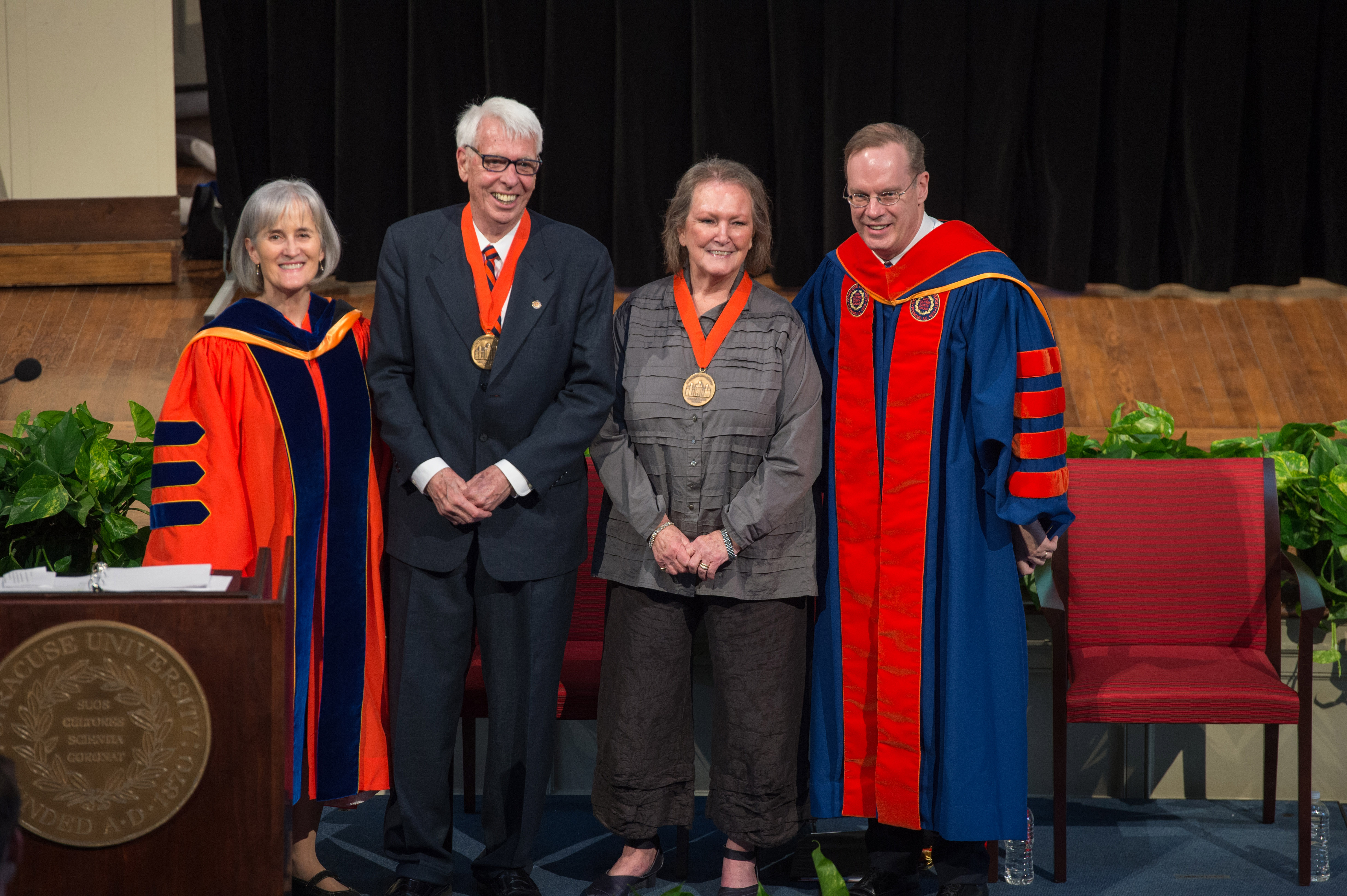 Vice Chancellor and Provost Michele Wheatly, Chancellor’s Medal recipients Sam and Carolyn Clemence, and Chancellor Kent Syverud on stage at Hendricks Chapel at the One University Awards Ceremony. 