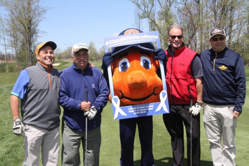 four people with Otto the Orange