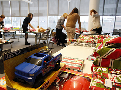 Photo: people wrapping gifts for holiday giving