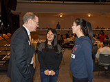 Chancellor Syverud talks with two female students