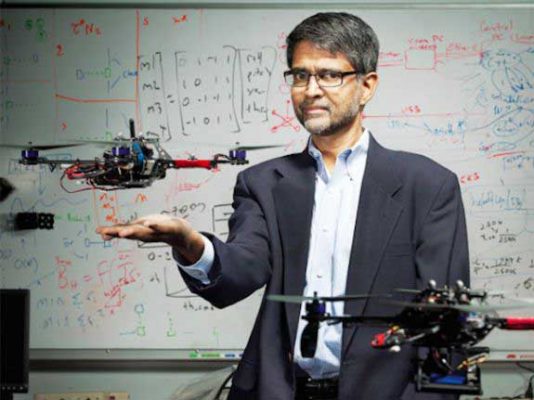 Vijay Kumar with a pair of aerial robots