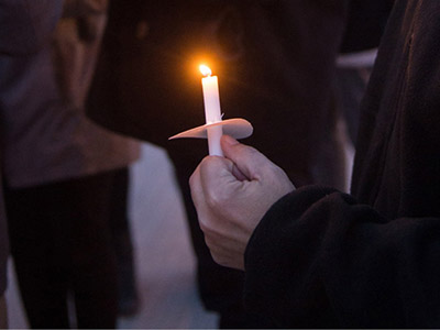 Student holding a candle