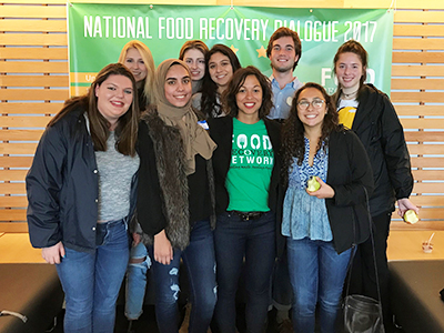 Food Recovery Network volunteers in front of green banner for their organization