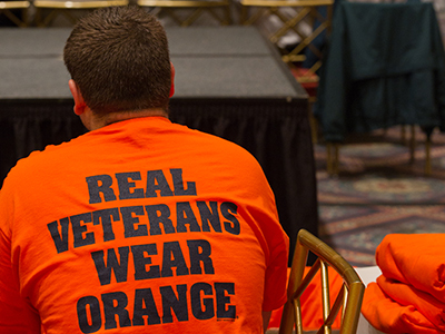 man wearing a 'Real Veterans Wear Orange' T-shirt