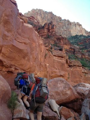 people hiking up mountain