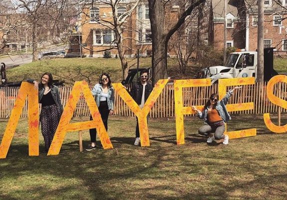 several people standing in front of giant letters that read Mayfest