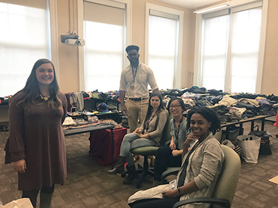 Students at the 2018 Trans Support Day, surrounded by clothes collected during the clothing drive.