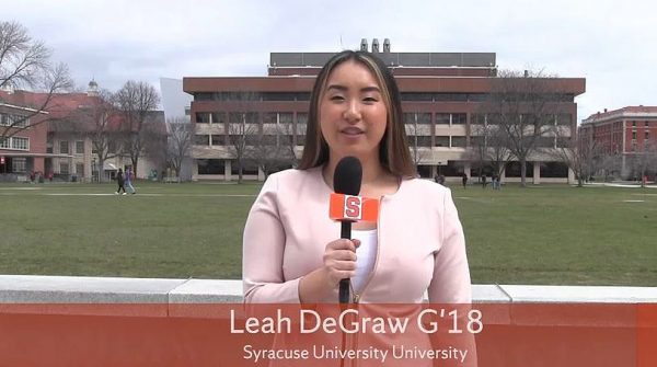 Leah DeGraw stands on the quad with a cuse cast mic in hand