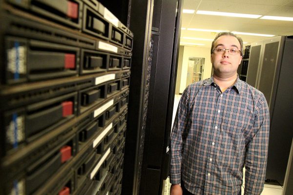 man standing in front of computer servers