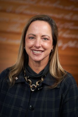Beth Kubala in front of a brown background.