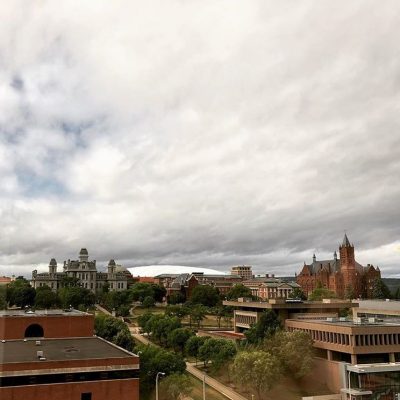 clouds passing over campus buildings