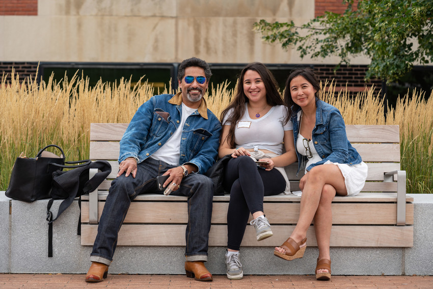 three people sitting on a bench