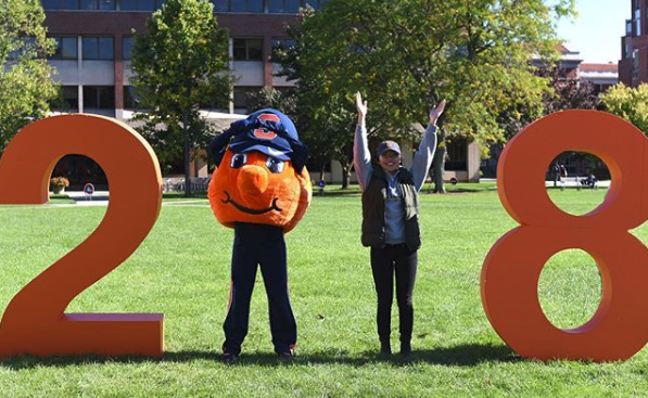 A student and Otto post with giant numbers for the Class of 2018