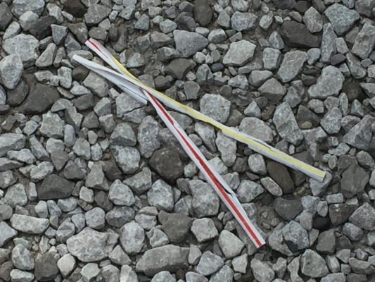plastic straws littered on gravel