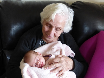 Elderly woman and newborn