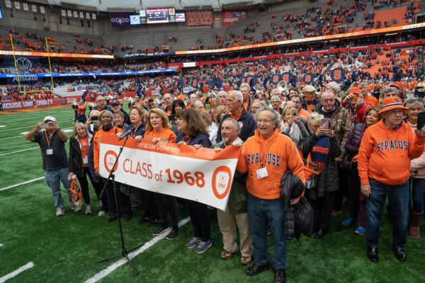 group of people with banner on football field