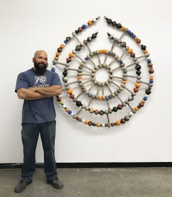man standing next to artwork