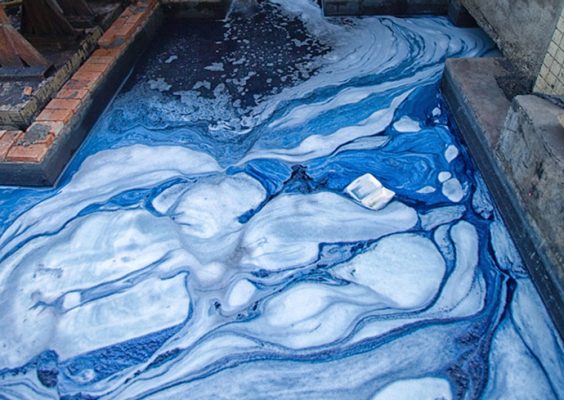 Blue dyed water flowing out of a factory.