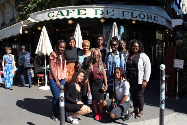 Students pose outside a Parisian café.