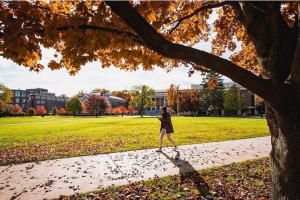 person walking across quad
