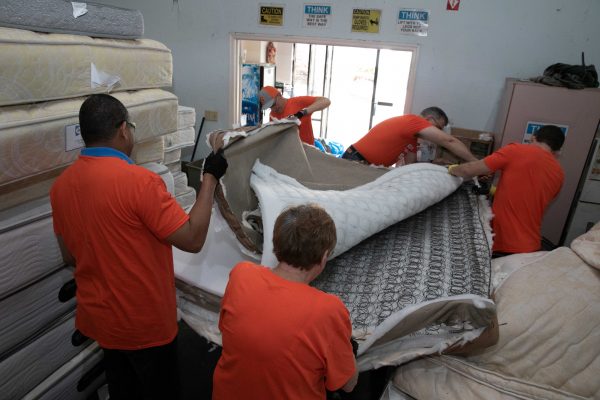 Volunteers assembling beds.