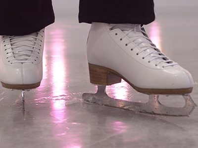 Photo of ice skates on ice.