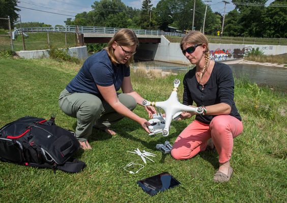Preparing a drone for launch along Onondaga Creek.