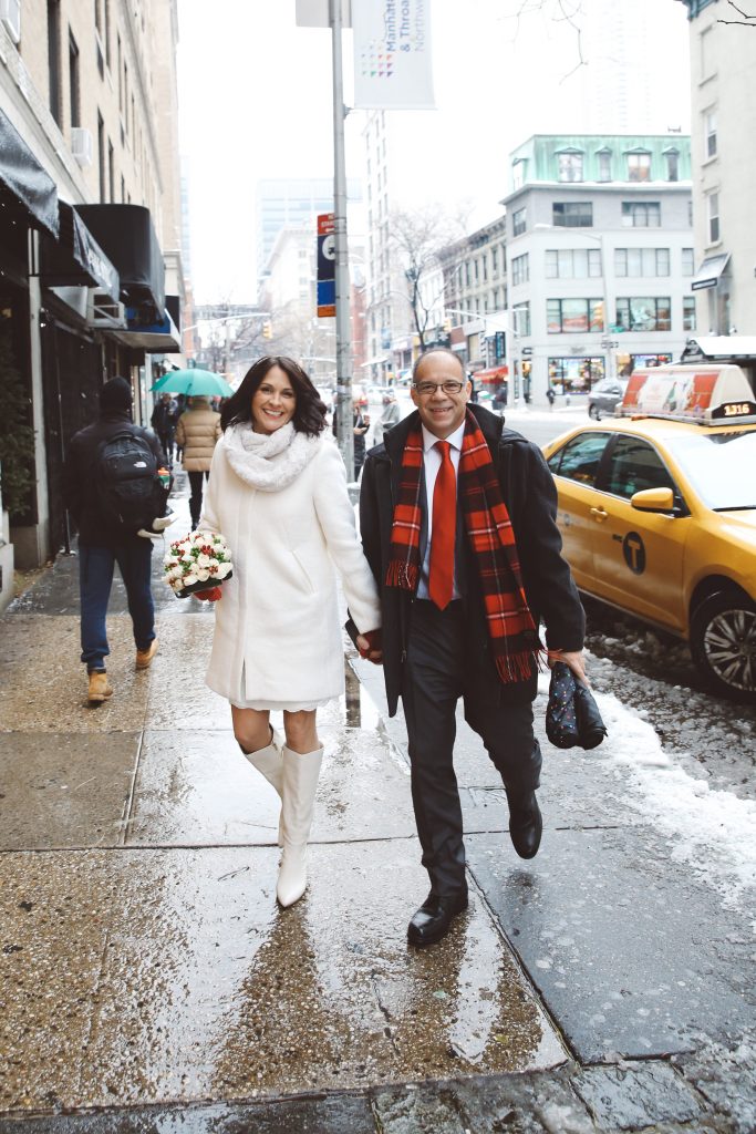 woman and man walking on city sidewalk