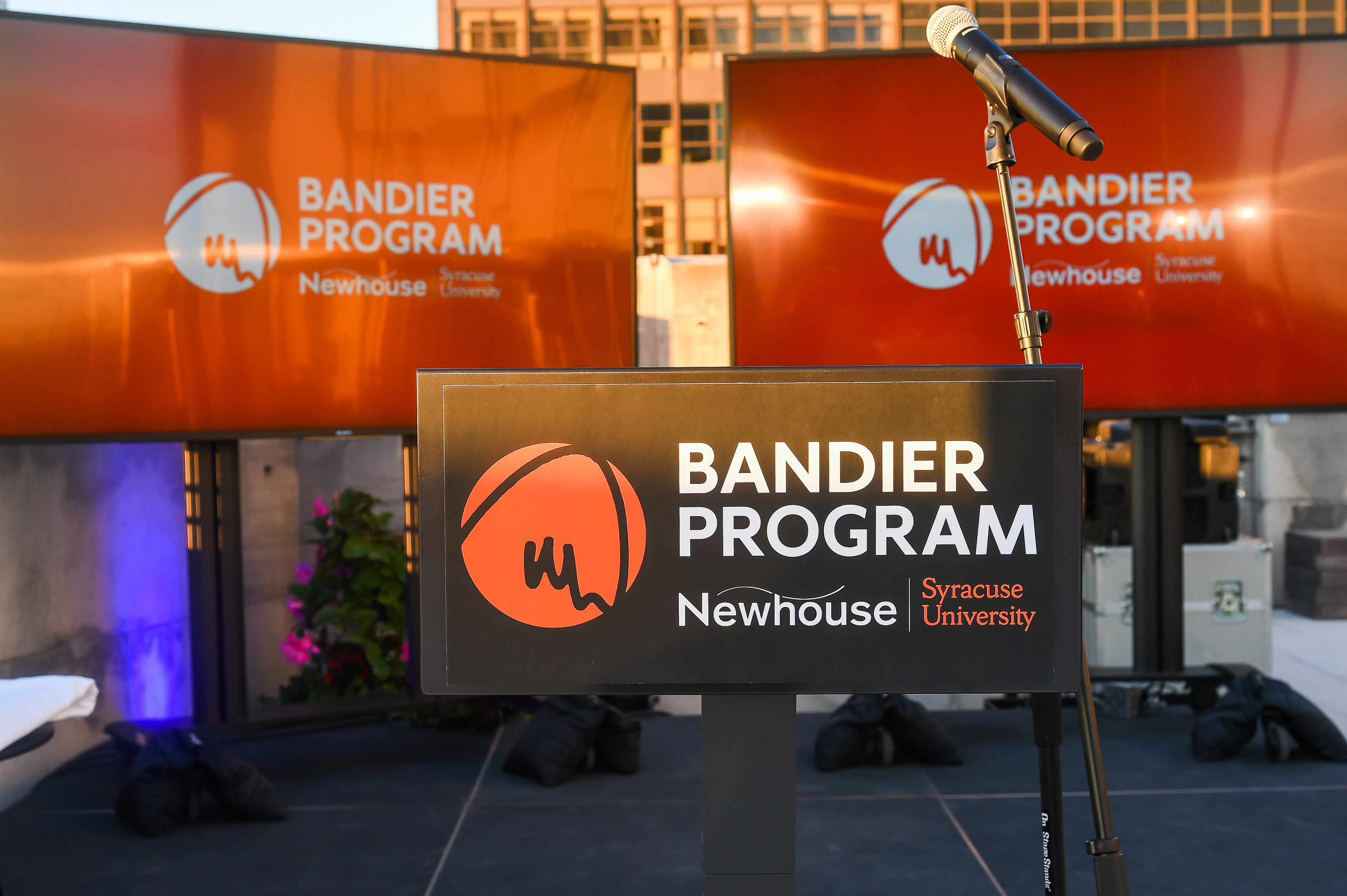 Bandier Program logo shown on three video monitors
