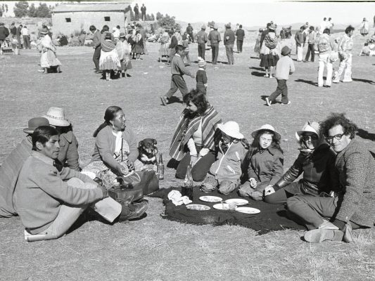 Old photo of people sitting together in a field