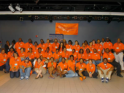 Students dressed in orange gathered for a group photo