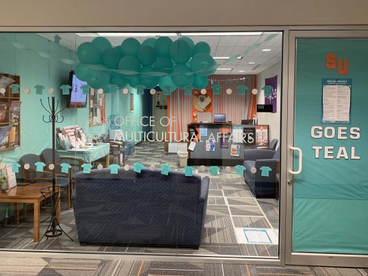Office of Multicultural Affairs decorated with teal balloons and paper