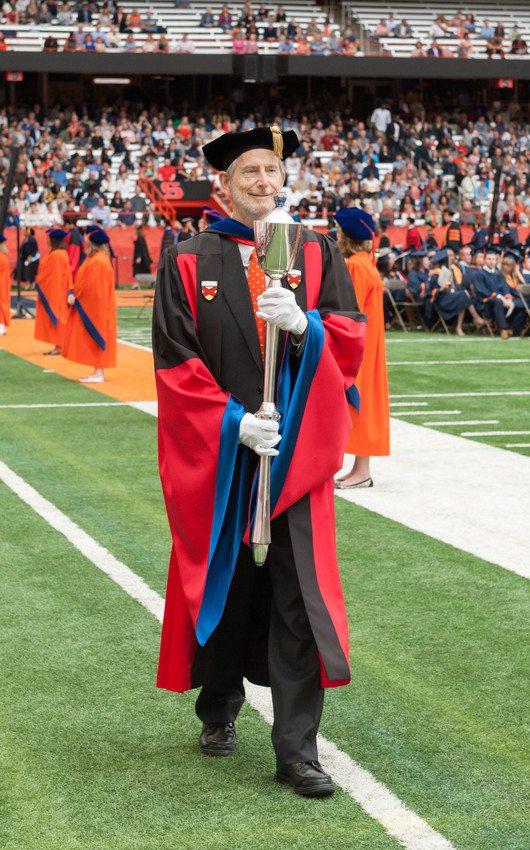 man holding mace at graduation