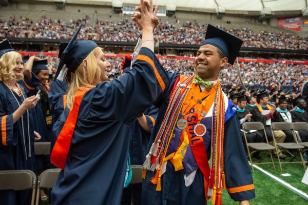 two graduates clapping hands