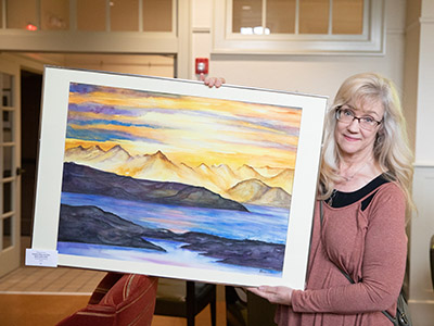 Woman holding a large painting