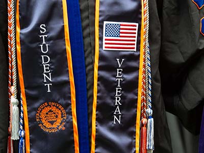 Commencement sashes showing "STUDENT" and "VETERAN"