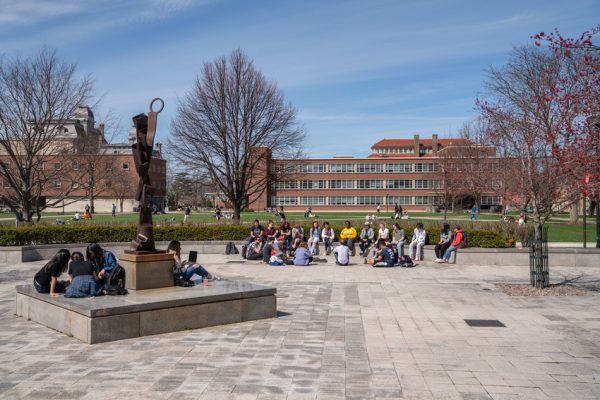 students and faculty sitting on courtyard on Quad