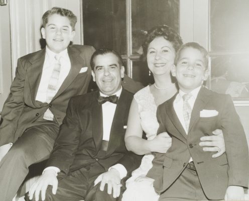 two boys sitting with two adults