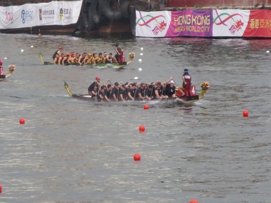 two boats of paddlers in dragon boats