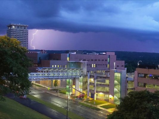 dark clouds and lightning strike over Dineen Hall