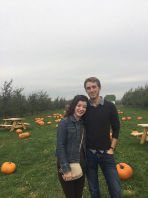 two people with pumpkins