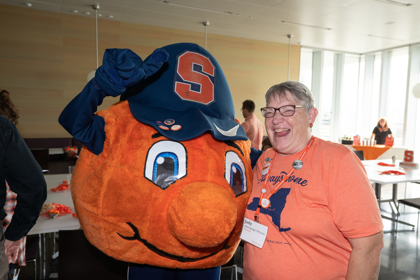 mascot posing with smiling woman