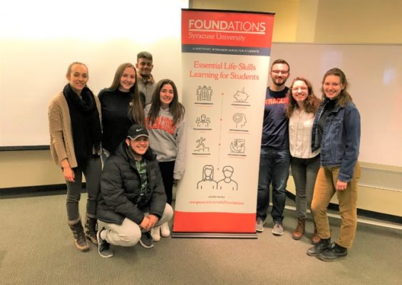 Students posing with a Spring 2019 Foundations poster