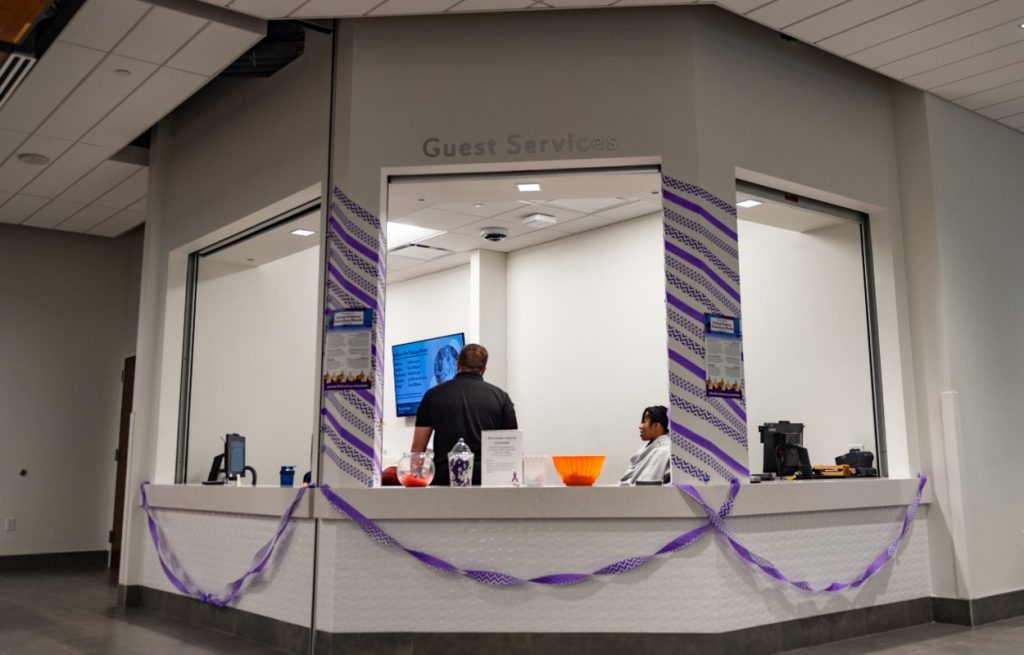 Streamers and purple decor surrounds Guest Services kiosk
