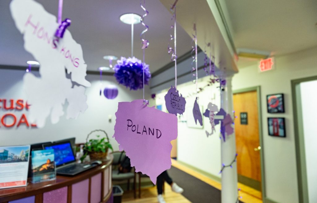 purple decorations hang from ceiling of office