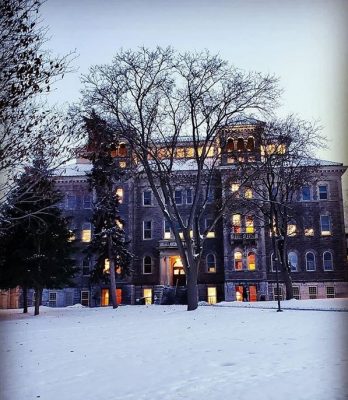 snow in grass in front of Smith Hall