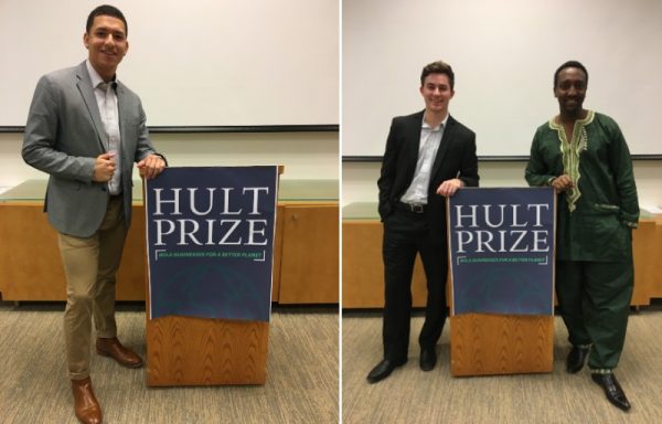 students pose at Hult Prize podium