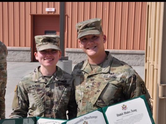 woman and man in military fatigues