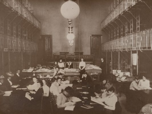 old photo of people in library