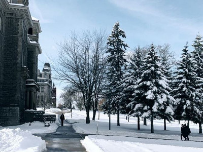 campus walkway with snow-covered trees